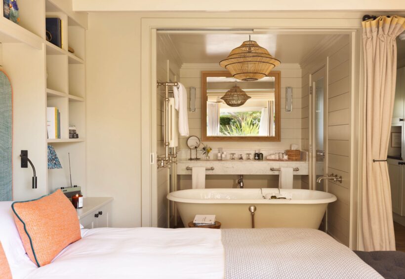 Luxury bedroom with huge roll top bath at boutique hotel near Rye beach