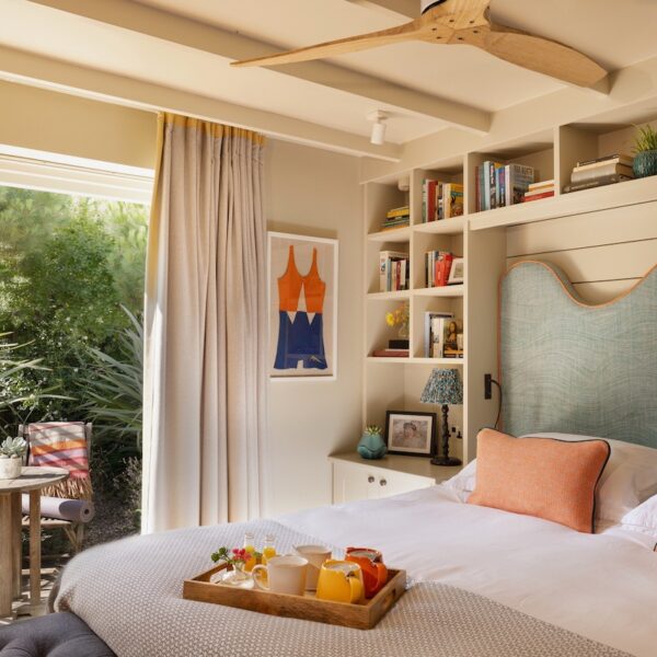 Bright hotel bedroom with built-in bookshelves